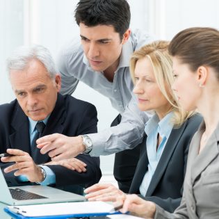 Team Of Business People Working Together On A Laptop